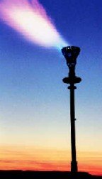 An external landfill gas flare looks dramatic at sunset.